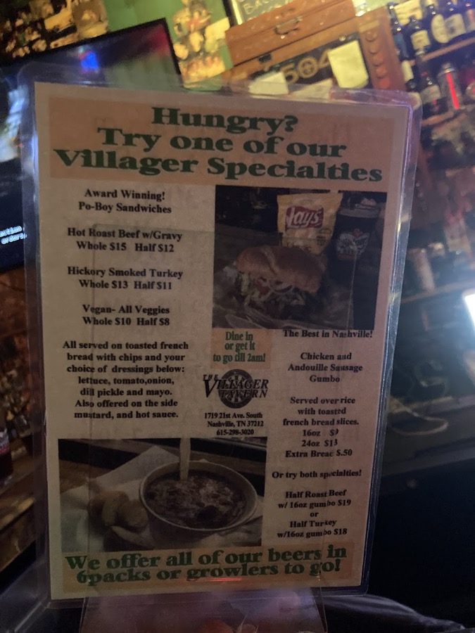 The printed Villager Specialties menu card posted on the wall of the bar